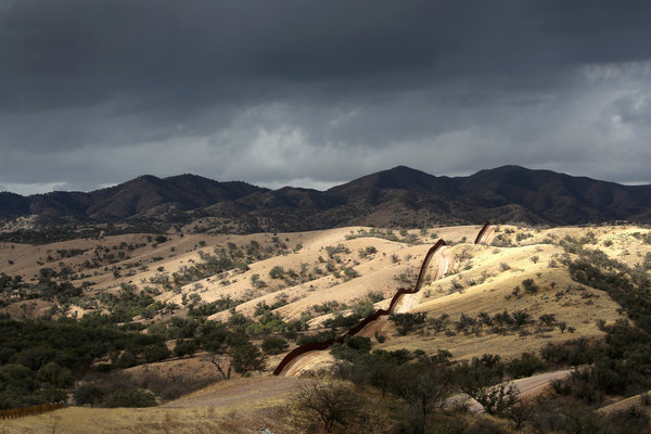 The U.S.-Mexico border fence stretches into the countryside on near Nogales, Ariz. (John Moore / Getty Images / March 8, 2013)