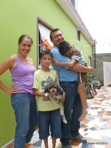 Pastor Victor C., Jessie, Elias and a tired Isais outside their new Villa Union home