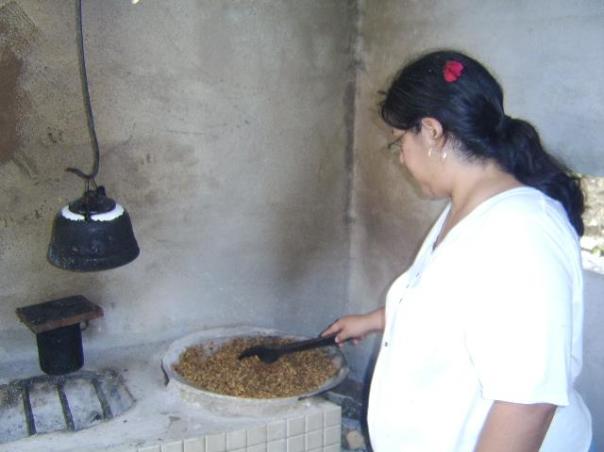 Toasting the coffee beans on a hot comal 